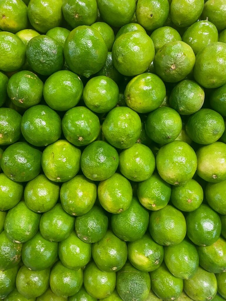 A large pile of limes sitting on top of each other