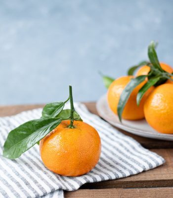 orange fruit on white table cloth